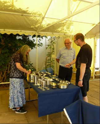 Keith admiring Patricia and Tony's items